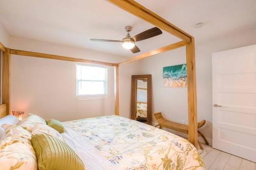 a bedroom with a bed and a ceiling fan at TOP RATED! Namaste Here steps to Flagler & Beach in New Smyrna Beach
