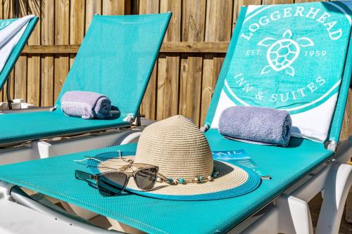a hat and sunglasses sitting on a beach chair at Loggerhead Inn and Suites in Surf City