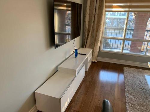 a living room with white furniture and a window at SUMPTUOUS HOUSE IN BEAUTIFUL NEIGHBORHOOD in Brampton