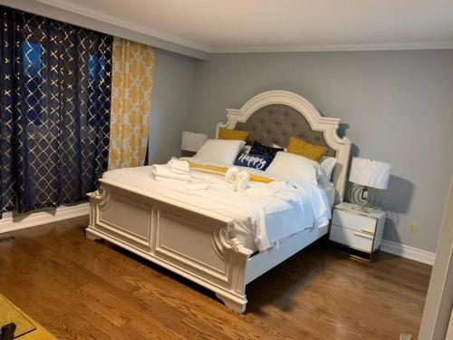a bedroom with a large bed with a large headboard at SUMPTUOUS HOUSE IN BEAUTIFUL NEIGHBORHOOD in Brampton