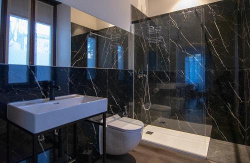 a bathroom with a sink and a toilet at Palazzo Lachman rooms in Trento