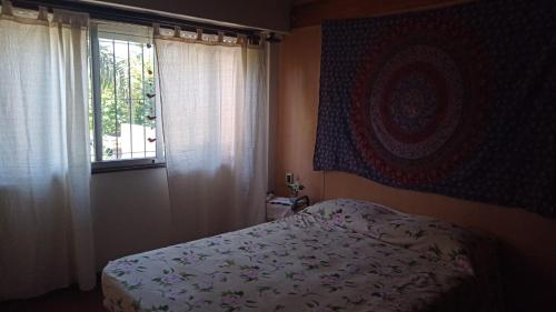 a bedroom with a bed and a window at CHE LOLITA HOUSE 3 in El Palomar