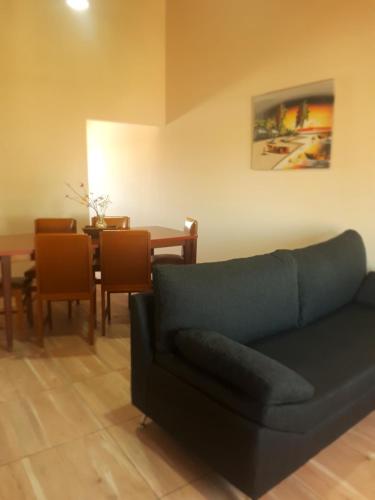 a living room with a couch and a table at Departamentos San Benito in Malargüe
