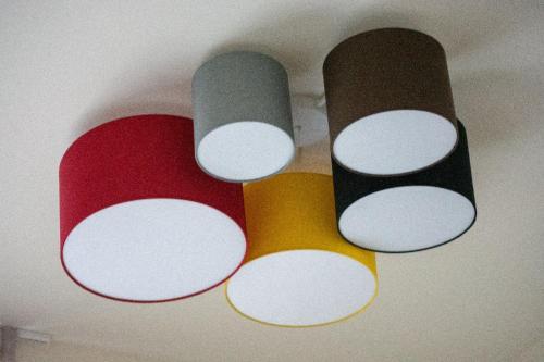 a group of different colored lights on a ceiling at Palazzo Lachman rooms in Trento