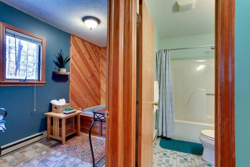 a bathroom with a toilet and a bath tub at Rustic Masthope Mountain Retreat with Private Sauna! in Hawley