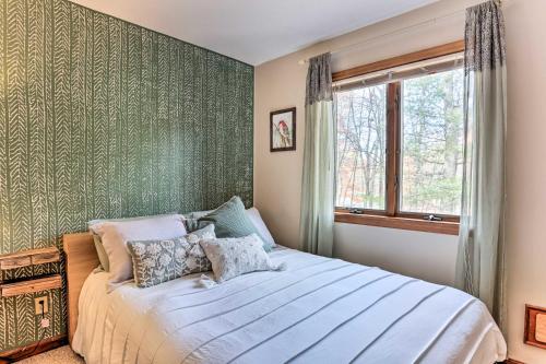 a bedroom with a bed with a green wall at Rustic Masthope Mountain Retreat with Private Sauna! in Hawley