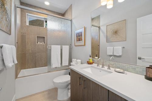 a white bathroom with a toilet and a sink at Red Door MCA#50500 in Manzanita