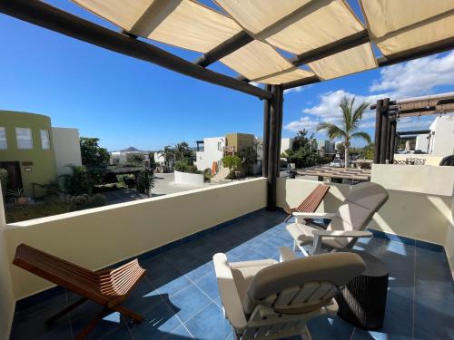 a patio with chairs and a table on a roof at Sea view, king-size bed, wheelchair access in Cabo San Lucas