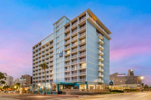 a tall building in a city at dusk at Best Western Corpus Christi in Corpus Christi
