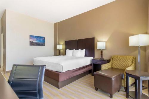 a hotel room with a bed and a desk and chair at Best Western Corpus Christi in Corpus Christi