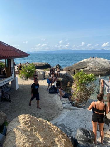 a group of people playing in the sand at the beach at Lighthouse Bungalows in Haad Rin