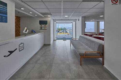 a waiting room with a bench in a building at City Express Junior by Marriott Guadalajara Periferico Sur in Guadalajara