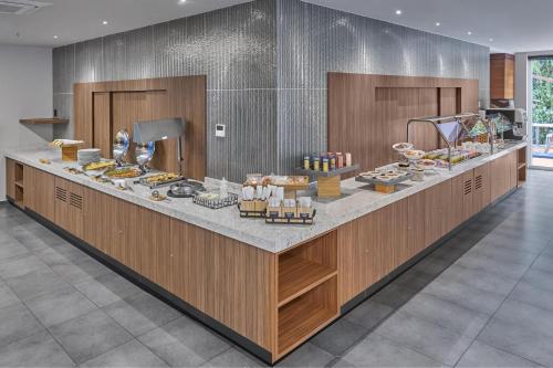 a buffet line with food on it in a restaurant at City Express Plus by Marriott Ciudad de México Santa Fe in Mexico City