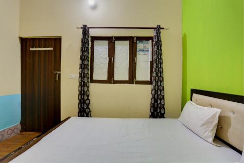 a bedroom with a large bed with a window at HOTEL SS PARADISE in Lucknow