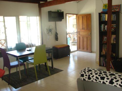 a living room with a table and chairs and a dining room at Casa Mapaná in Minca