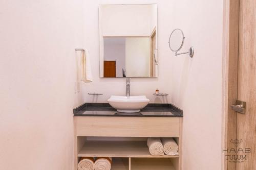 a bathroom with a sink and a mirror at Kaab Tulum in Tulum