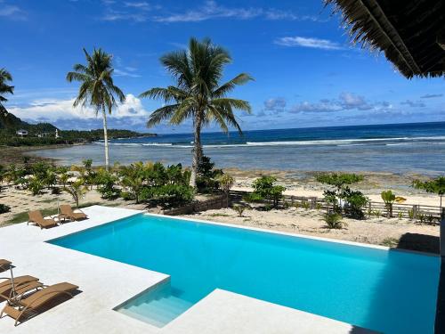 a swimming pool with a view of the beach at Yapak Beach Villas in San Isidro