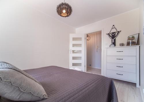 Postel nebo postele na pokoji v ubytování Bianco Apartament