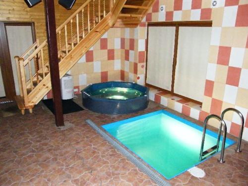 a room with a swimming pool in a house at Pakavciems pirts in Riga
