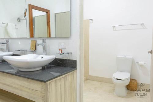 a bathroom with a sink and a toilet at Kaab Tulum in Tulum