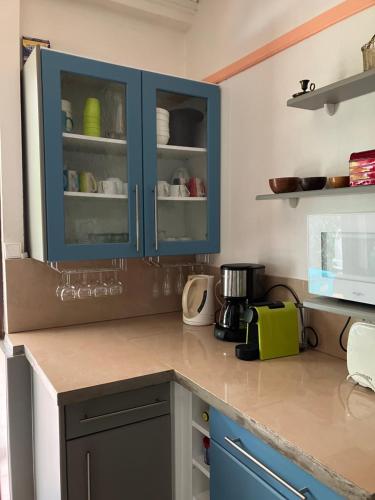 a kitchen with blue cabinets and a counter top at Villa Les Gallières in Pointe-Noire