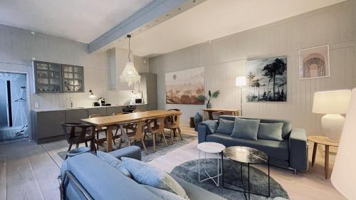 a living room with a blue couch and a table at ApartmentInCopenhagen Apartment 1577 in Copenhagen