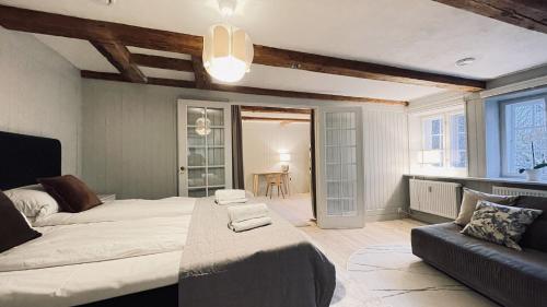 a bedroom with a large bed and a couch at ApartmentInCopenhagen Apartment 1577 in Copenhagen