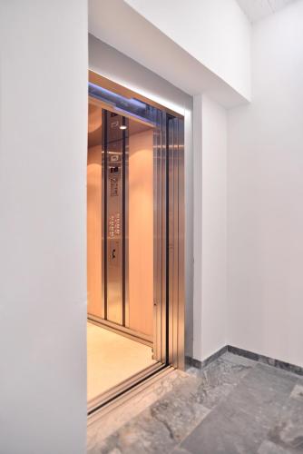 an elevator in a building with a glass door at Erato Hotel in Agia Marina Aegina