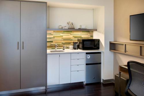 a small kitchen with a sink and a microwave at Element Boston Seaport District in Boston