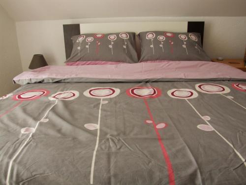 a bed with a blanket with hello kitty decorations on it at Apartment Metlača in Perušić