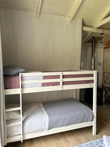 two bunk beds are in a room with a ceiling at QUELEN AUSTRAL in Hornopiren
