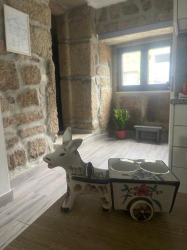 a toy cow pulling a cart in a room at Casa da Burra in Alijó