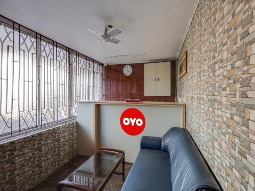 a room with a couch and aype sign on the wall at Vsv Guest House Maduravoyal in Chennai