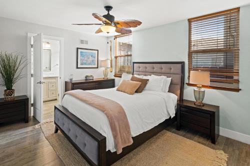 a bedroom with a large bed and a ceiling fan at Stunning Beach Home - large patio, parking, ac & dog friendly! in San Diego