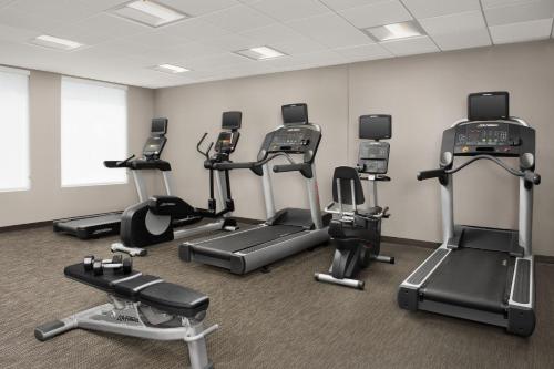 a gym with several cardio machines in a room at Courtyard Jacksonville Flagler Center in Jacksonville