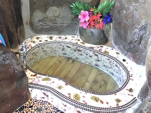 a bathroom sink with a vase of flowers on it at COZY Inn Free Shuttle service in Nikko