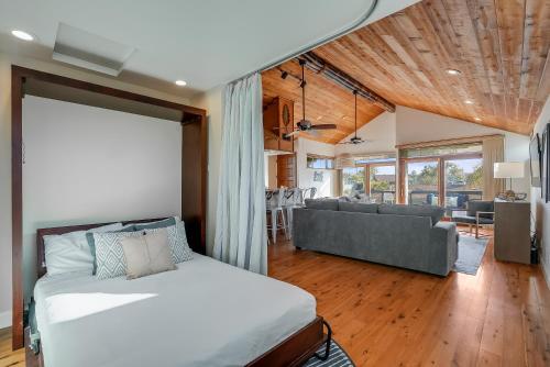 a bedroom with a bed and a living room at Stunning South Mission Beach Home - AC, Private Patio, Grill and Garage! in San Diego