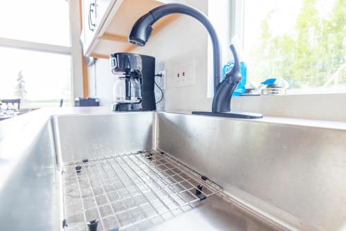 a kitchen sink with a water faucet at Lake Vista Chalet - 1BR, Full Kitchen, Wi-Fi in Kenai