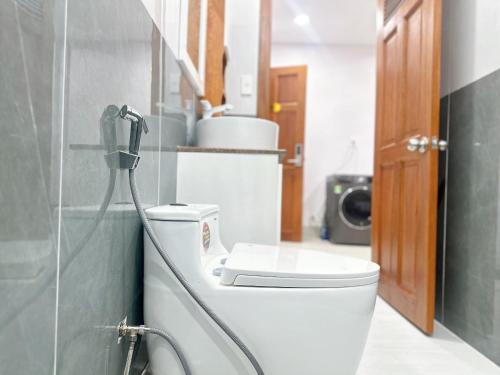 a bathroom with a toilet and a shower at Milanesa Hotel and Apartment in Vung Tau