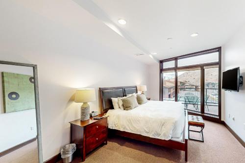 a bedroom with a bed and a large window at Pearl At Jackson #203 in Jackson