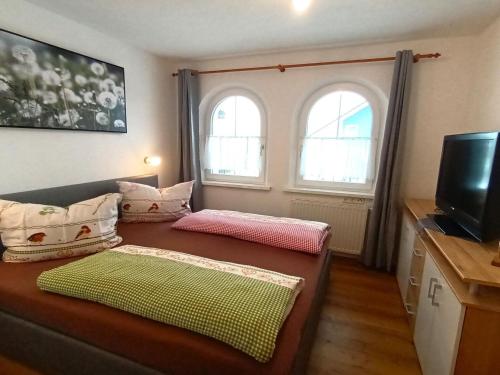 a small room with a couch and two windows at Nice holiday home in Hochgallmigg with terrace in Hochgallmig