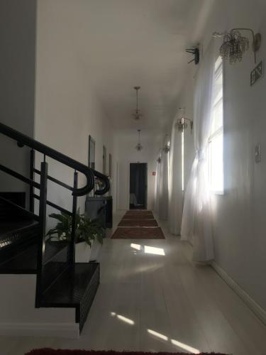 a hallway of a building with a staircase and a stair case at Hotel pousada porto real in Morretes