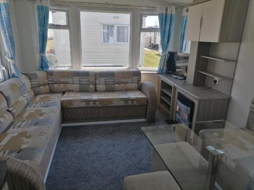 a living room with couches and a tv at Seaside Delight - Close to the beach in Kent