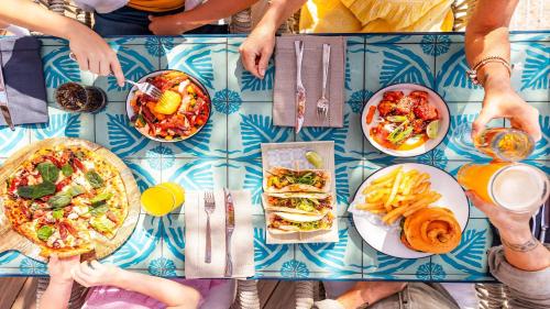 a group of people sitting at a table with food at InterContinental Sanctuary Cove Resort by IHG in Gold Coast