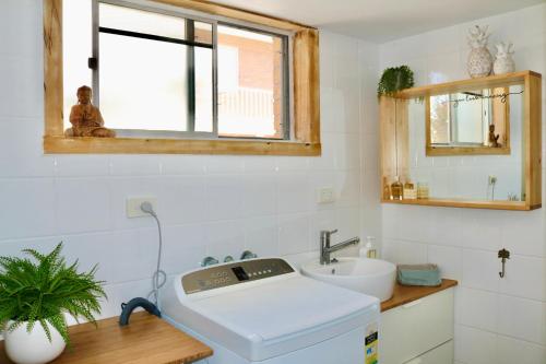 a bathroom with a sink and a window at Surf Shack in Iconic Rainbow Bay - Coolangatta QLD (pet friendly) in Gold Coast
