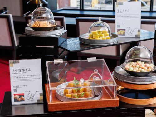 a display of food in glass containers on a table at Asakusa View Hotel Annex Rokku in Tokyo
