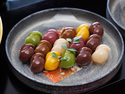 a plate of different types of fruit on a table at Asakusa View Hotel Annex Rokku in Tokyo