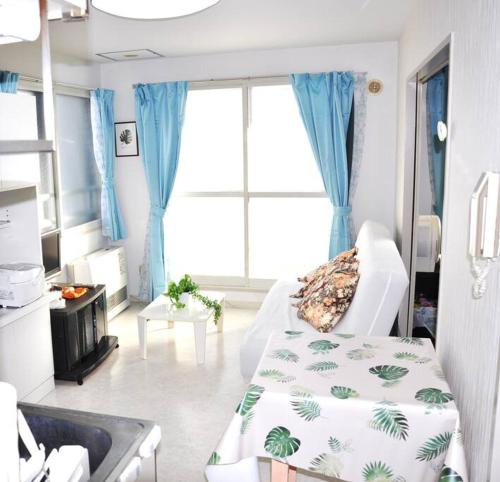 a hospital room with a bed and a sink at アイム北10条 in Sapporo