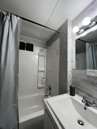 a white bathroom with a sink and a shower at Cozy Guest House in Bellingham