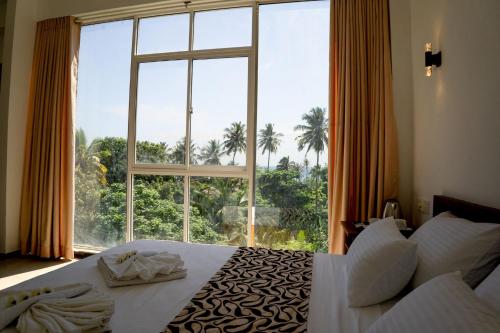 Кровать или кровати в номере Tevins Place - Unawatuna